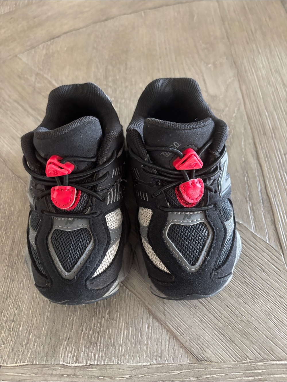 New Balance Kids Black and Gray Sneakers with red Lace Toggles